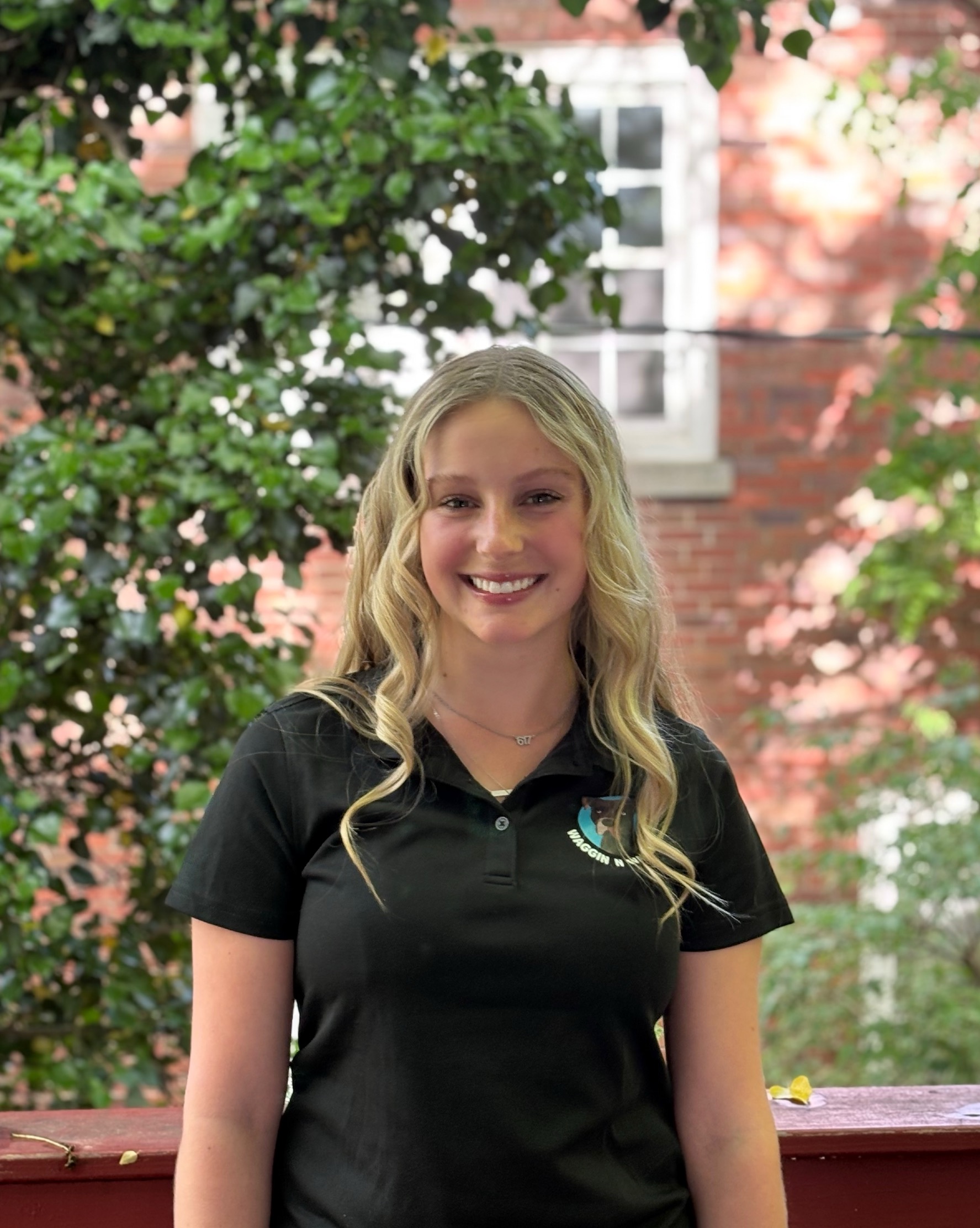 women standing in front of tree